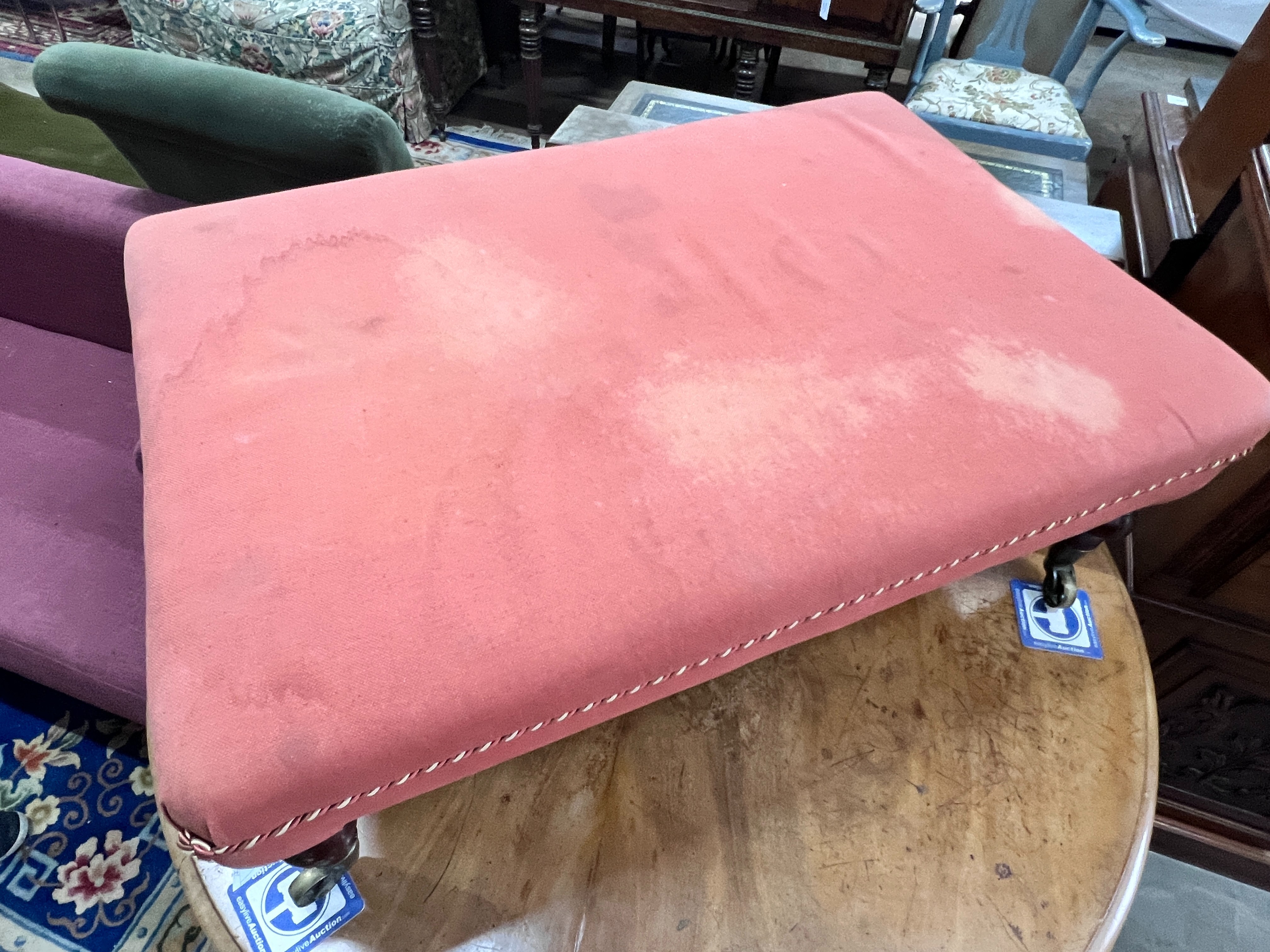A Victorian rectangular stool on turned mahogany legs with spoked castors, length 93cm, width 64cm, height 35cm
